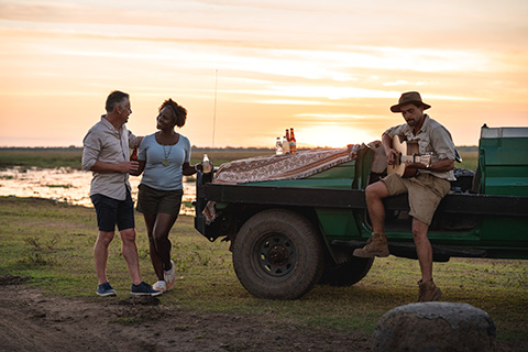 A guide entertains people on a safari.