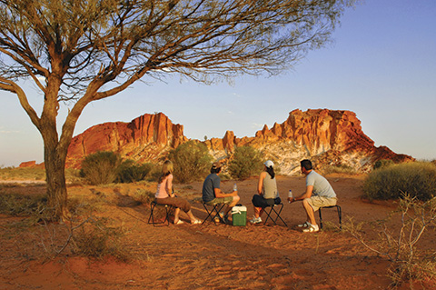 A group of people looking at the scenic Rainbow Valley