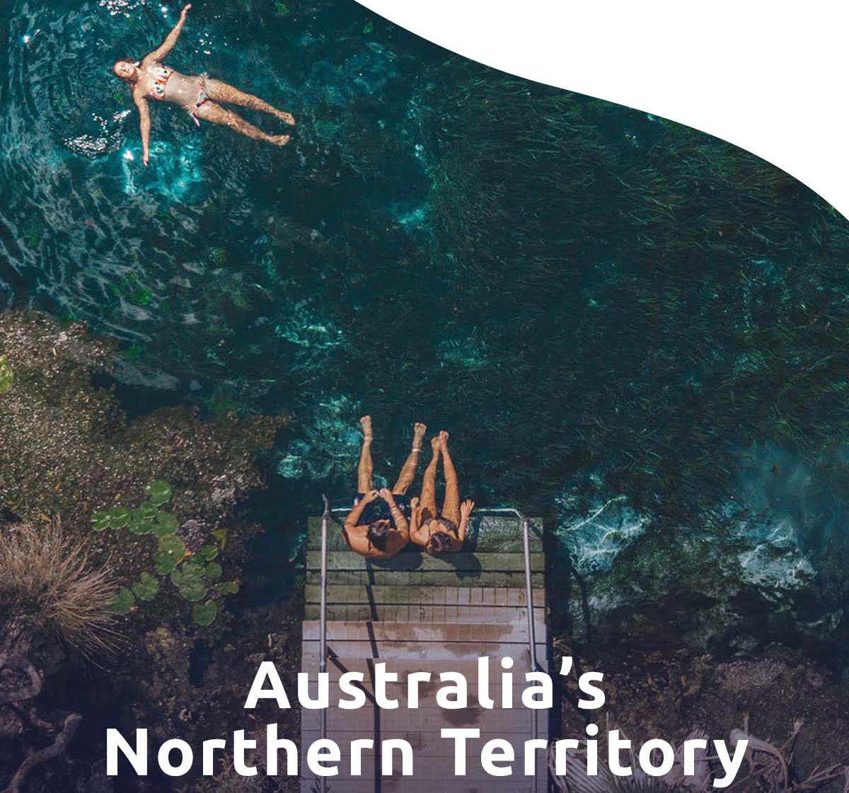 Friends swim in the Bitter Springs thermal pool. A headline reads: Australia's Northern Territory.