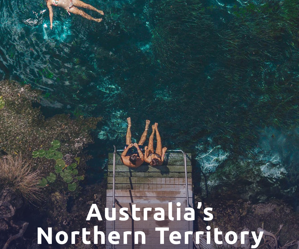 Friends swim in the Bitter Springs thermal pool. A headline reads: Australia's Northern Territory.