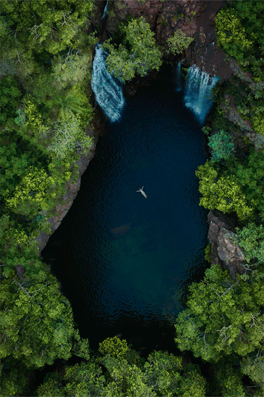 A woman floats in the idyllic Bitter Springs thermal pool.